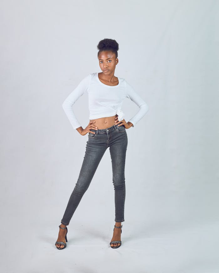 Chic portrait of an African female model striking a confident pose in trendy fashion wear.
